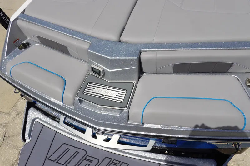 Slide: The Image of 2021 Malibu Wakesetter 25 LSV boat interior with gray seating and blue accents. - 9