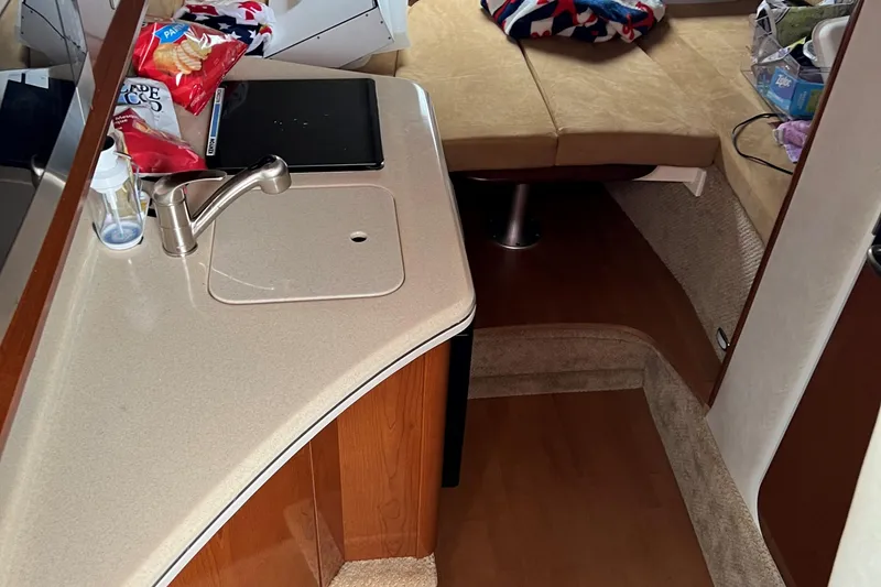 Slide: The Image of Interior of 2011 Sea Ray 280 Sundancer with kitchenette and seating area. - 11