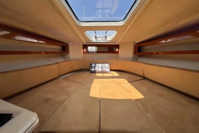 Slide: The Image of Interior cabin of 2011 Sea Ray 280 Sundancer with skylight and beige seating. - 14