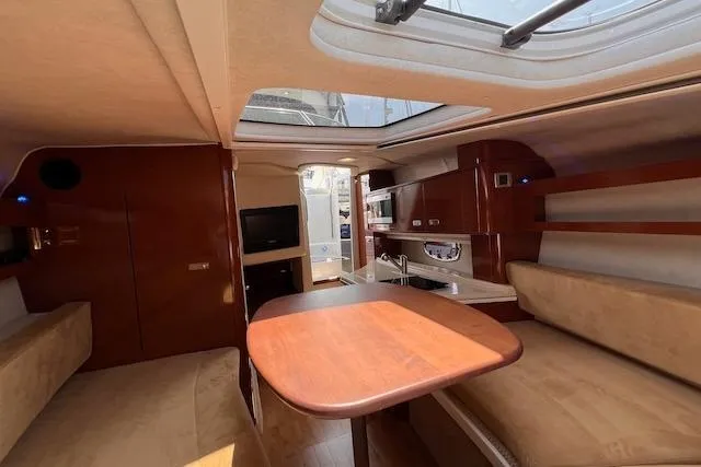 Slide: The Image of Interior of 2011 Sea Ray 280 Sundancer yacht with wood finishes and seating area. - 15