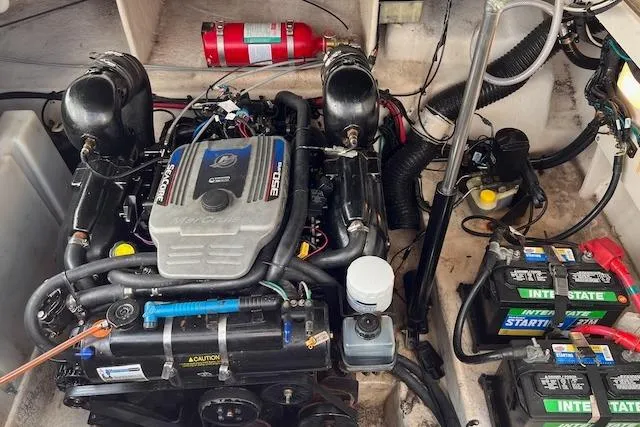 Slide: The Image of Engine compartment of a 2011 Sea Ray 280 Sundancer with batteries and fire extinguisher. - 21