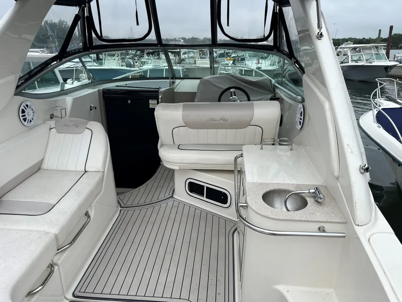 Slide: The Image of 2011 Sea Ray 280 Sundancer interior with seating, sink, and steering wheel. - 4