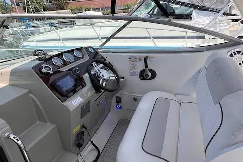 Slide: The Image of 2011 Sea Ray 280 Sundancer boat cockpit with steering wheel and gauges. - 7