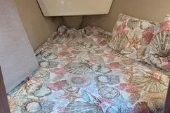 Slide: The Image of Cozy cabin interior of 1992 Hunter 33.5 sailboat with seashell-patterned bedding. - 10