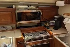 Slide: The Image of 1992 Hunter 33.5 yacht kitchen with stove, microwave, and coffee maker. - 11