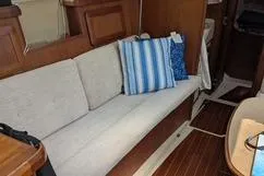 Slide: The Image of Interior of 1992 Hunter 33.5 sailboat with cozy seating and striped cushions. - 12
