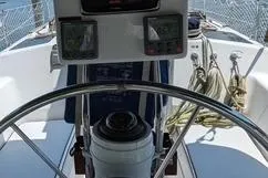 Slide: The Image of Steering wheel and controls of a 1992 Hunter 33.5 sailboat cockpit. - 4