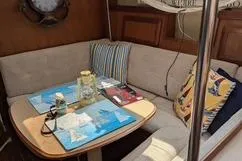 Slide: The Image of Cozy interior of 1992 Hunter 33.5 sailboat with cushioned seating and nautical decor. - 9