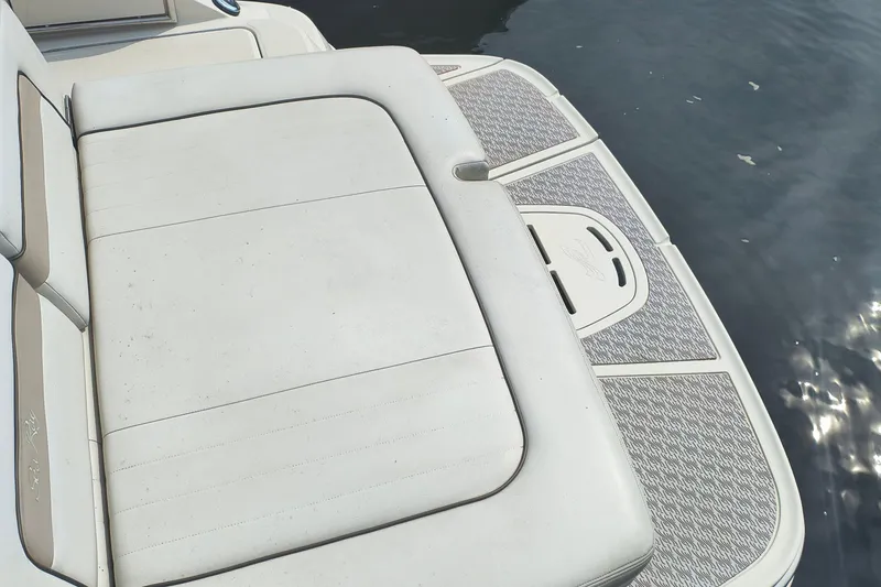 Slide: The Image of 2009 Sea Ray 280 Sundeck boat seating and swim platform by the water. - 10
