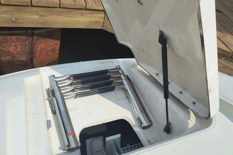 Slide: The Image of Open storage compartment on a 2009 Sea Ray 280 Sundeck boat, showing metal components. - 11