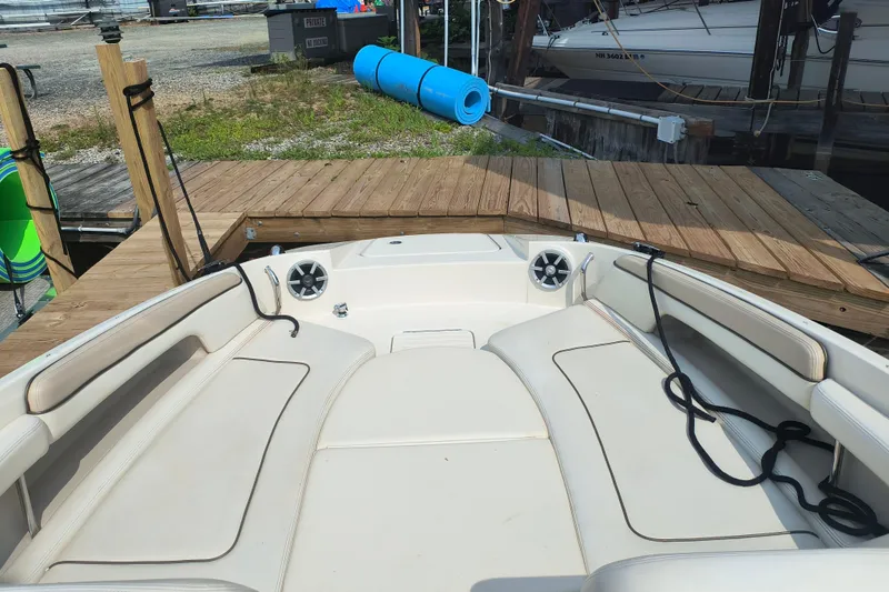 Slide: The Image of 2009 Sea Ray 280 Sundeck boat interior at dock, featuring spacious seating and speakers. - 2