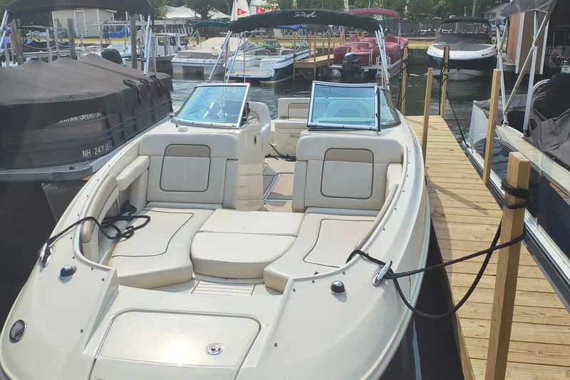 Slide: The Image of 2009 Sea Ray 280 Sundeck boat docked at a marina, featuring spacious seating. - 3