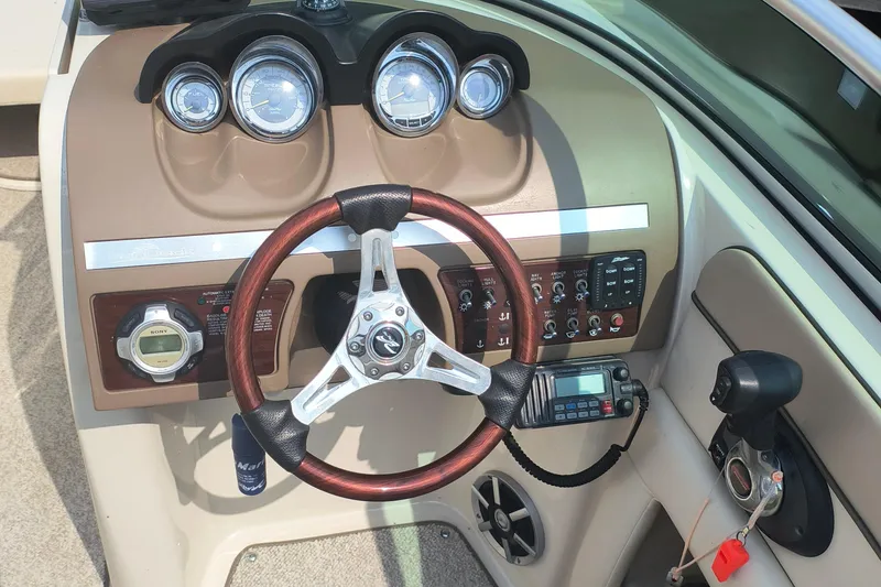 Slide: The Image of 2009 Sea Ray 280 Sundeck dashboard with steering wheel and control panel. - 5