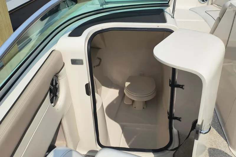 Slide: The Image of 2009 Sea Ray 280 Sundeck boat interior with compact marine toilet. - 7