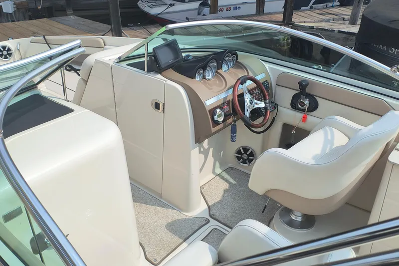 Slide: The Image of 2009 Sea Ray 280 Sundeck boat interior with steering wheel and dashboard controls. - 8