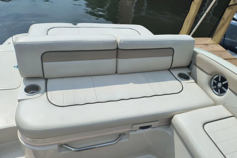 Slide: The Image of 2009 Sea Ray 280 Sundeck boat interior with cushioned seating and cup holders. - 9