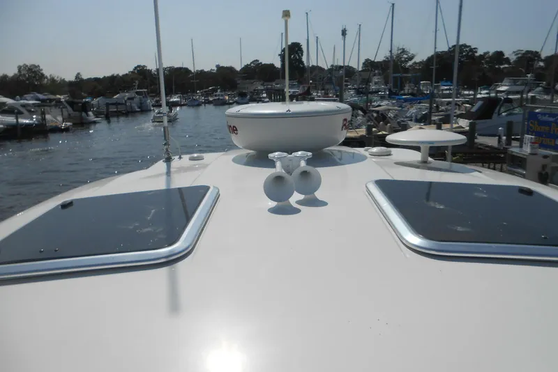 Slide: The Image of 2017 Formula 37 PC yacht docked at a marina, showcasing deck features and nearby boats. - 10