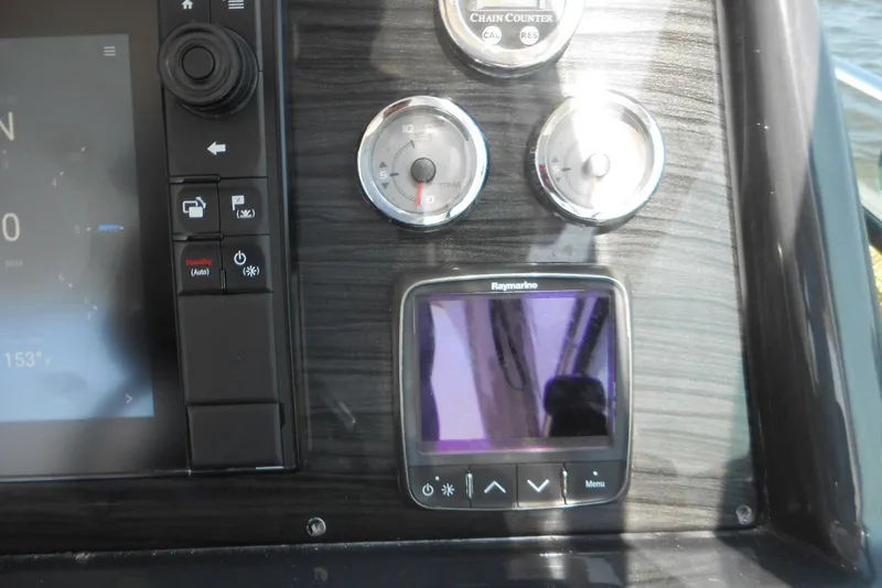 Slide: The Image of Control panel of a 2017 Formula 37 PC boat with gauges and Raymarine display. - 25