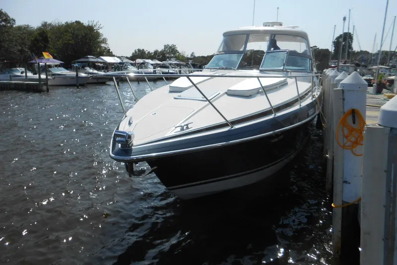Slide: The Image of 2017 Formula 37 PC boat docked at a marina, surrounded by water and other boats. - 3