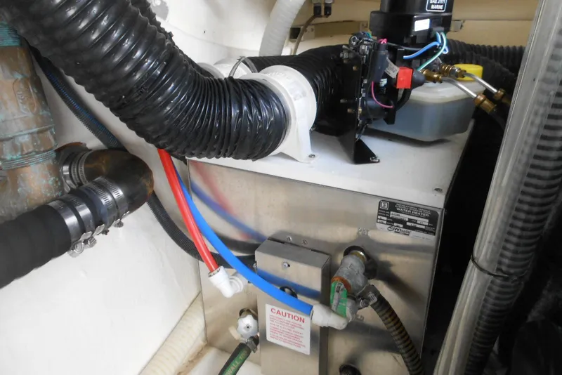Slide: The Image of Engine room of 2017 Formula 37 PC boat with water heater and hoses. - 36
