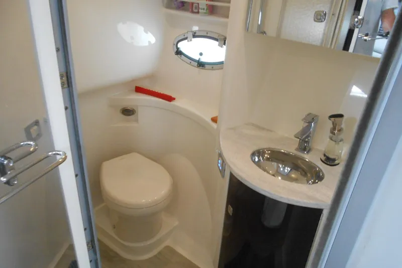 Slide: The Image of 2017 Formula 37 PC yacht bathroom with toilet, sink, and porthole window. - 46