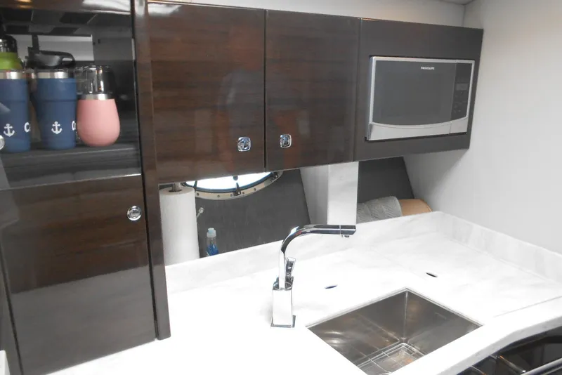 Slide: The Image of Modern kitchen area in a 2017 Formula 37 PC yacht with sleek cabinetry and appliances. - 47