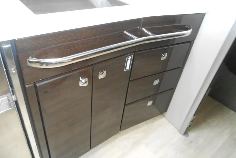 Slide: The Image of 2017 Formula 37 PC yacht interior with sleek dark wood cabinetry and modern fixtures. - 48