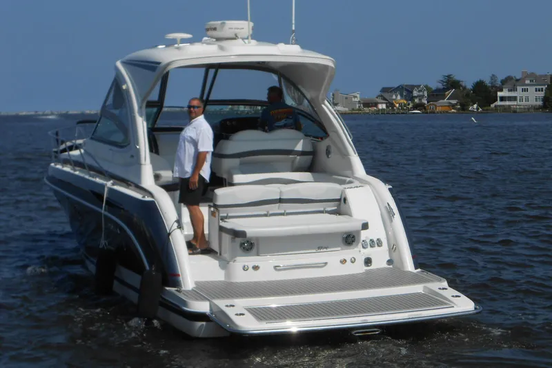 Slide: The Image of 2017 Formula 37 PC yacht cruising on a sunny day near coastal homes. - 5