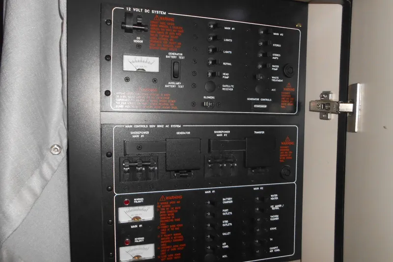 Slide: The Image of Electrical control panel on a 2017 Formula 37 PC boat, featuring various switches and meters. - 51