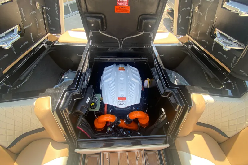 Slide: The Image of 2023 Tigé 23ZX boat engine compartment with open hatches and visible components. - 10