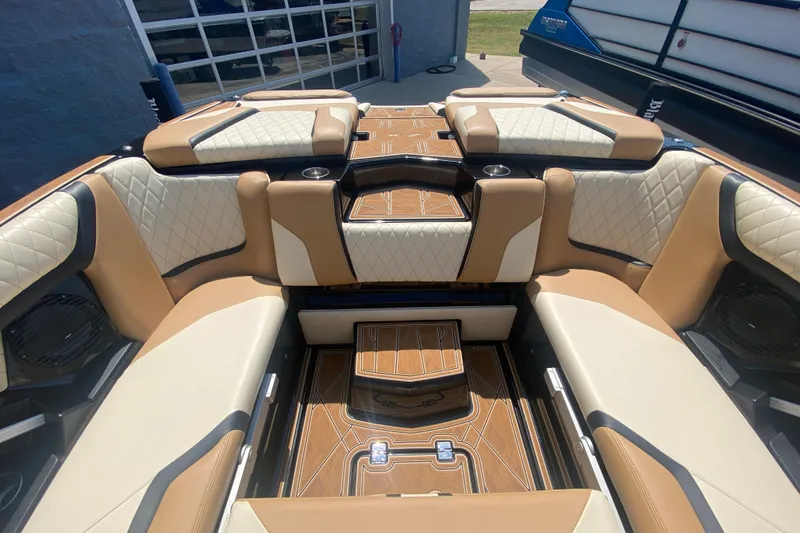 Slide: The Image of Luxurious interior of 2023 Tigé 23ZX boat with tan and cream seating. - 12