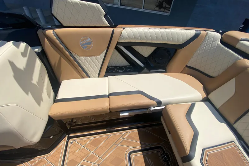 Slide: The Image of 2023 Tigé 23ZX boat interior with tan and cream quilted seating. - 15