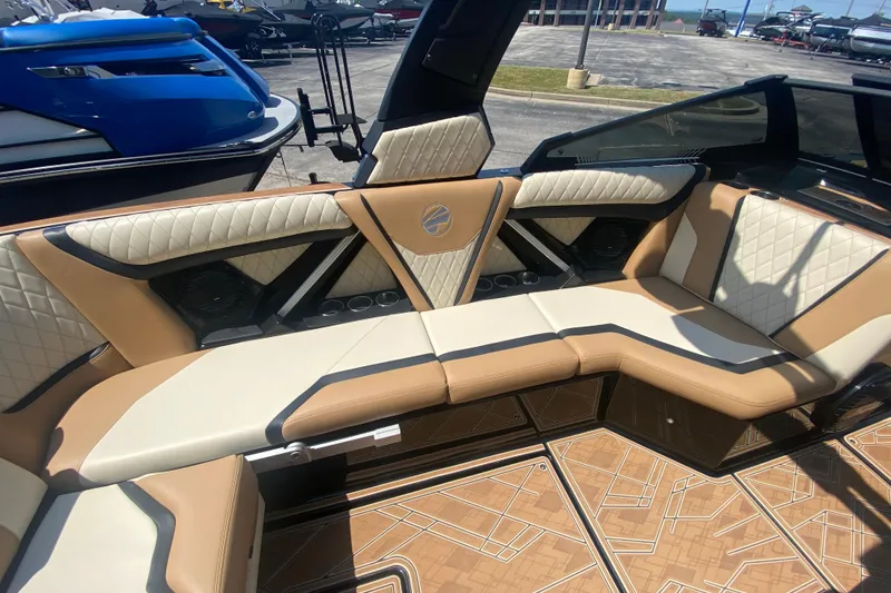 Slide: The Image of 2023 Tigé 23ZX boat interior with luxurious tan and white seating, featuring quilted upholstery. - 17