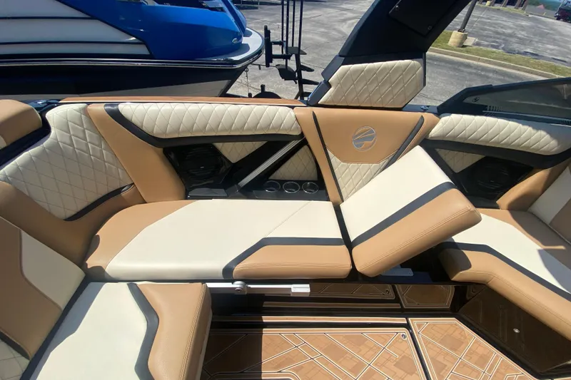 Slide: The Image of 2023 Tigé 23ZX boat interior with luxurious tan and cream seating, diamond stitching, and cup holders. - 18