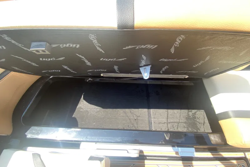 Slide: The Image of 2023 Tigé 23ZX boat storage compartment with open lid, showcasing interior space. - 20