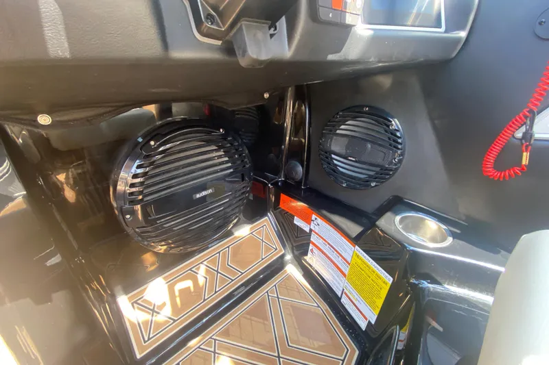 Slide: The Image of 2023 Tigé 23ZX boat interior with audio system and control panel. - 24