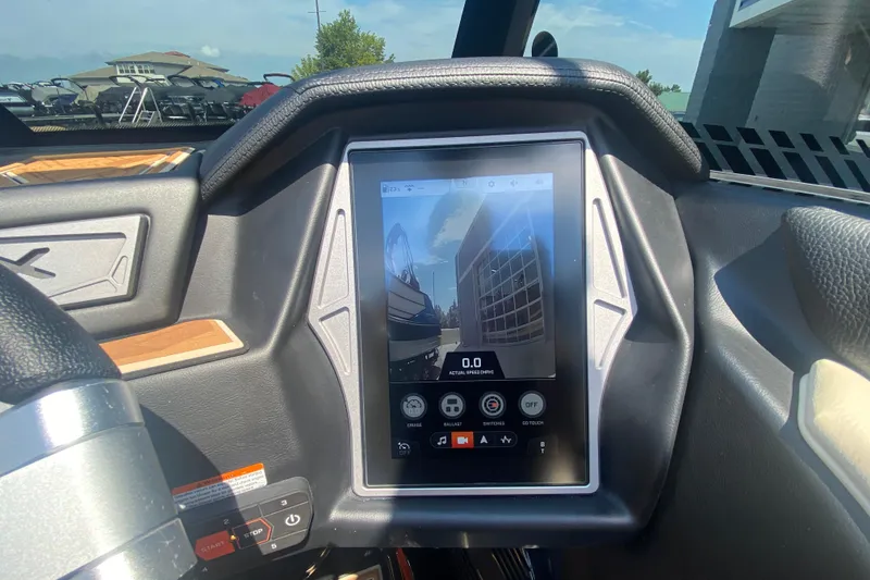 Slide: The Image of 2023 Tigé 23ZX boat dashboard with touchscreen display showing controls and speed. - 27