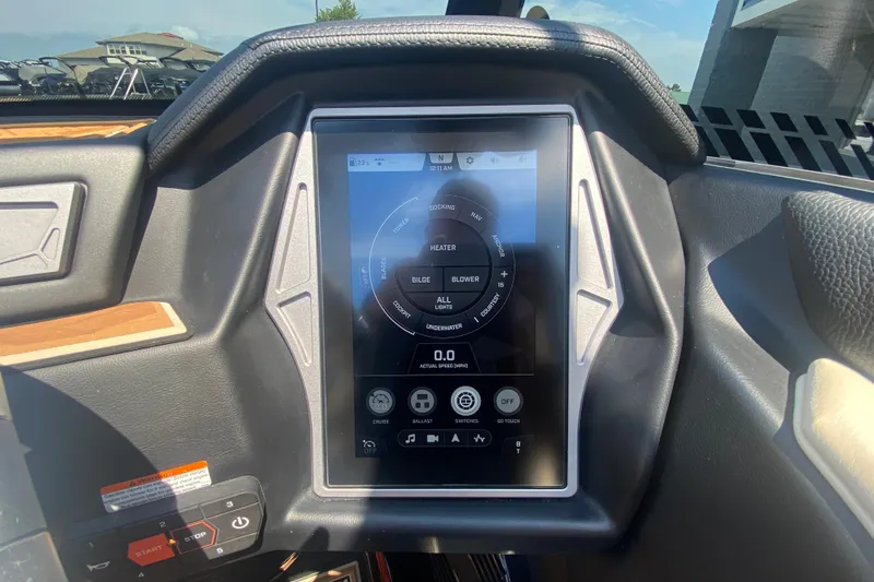 Slide: The Image of 2023 Tigé 23ZX boat dashboard with touchscreen control panel and navigation display. - 28