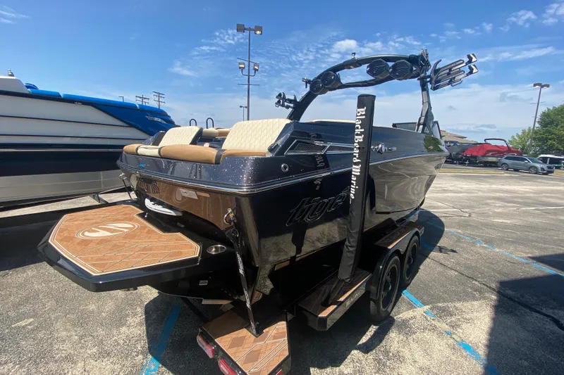 Slide: The Image of 2023 Tigé 23ZX boat in parking lot, featuring sleek design and modern amenities. - 35