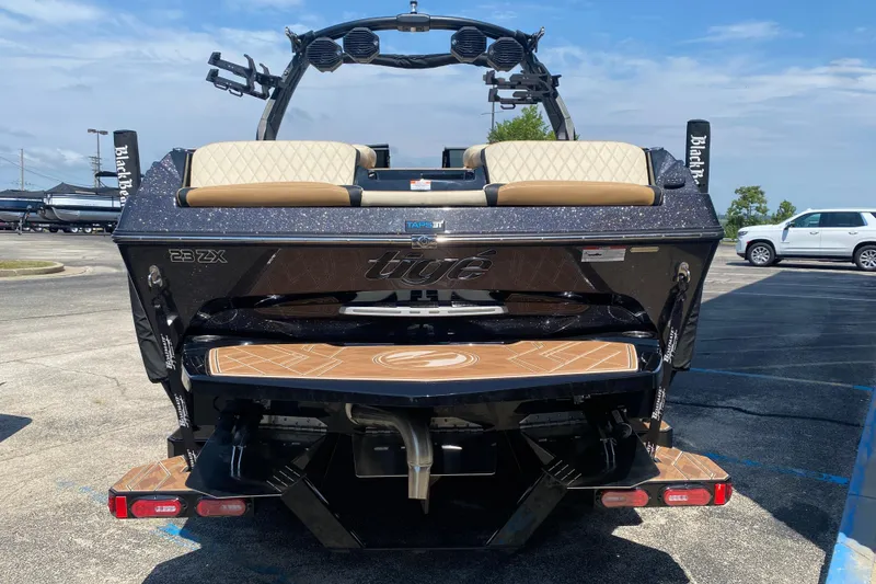 Slide: The Image of 2023 Tigé 23ZX boat rear view with sleek design and modern features. - 4