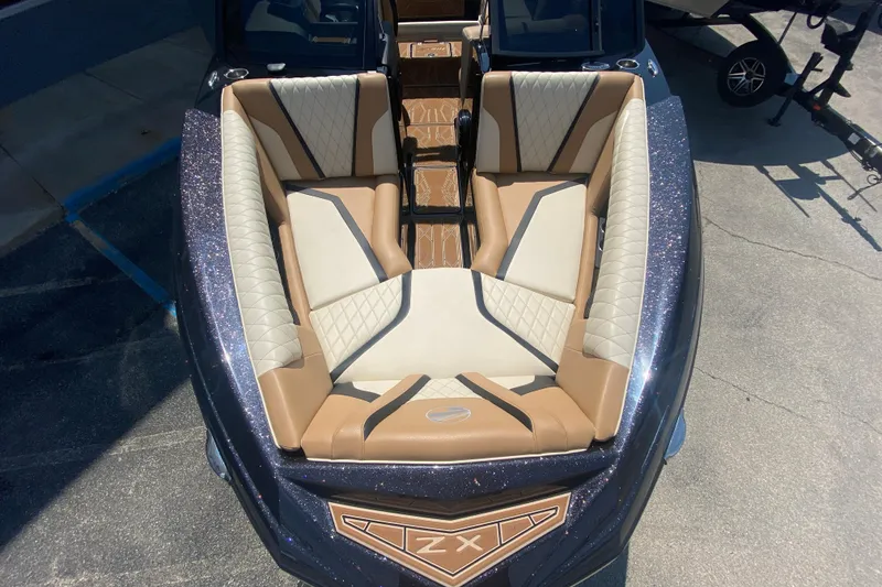 Slide: The Image of 2023 Tigé 23ZX boat with luxurious tan and white seating, viewed from above. - 5