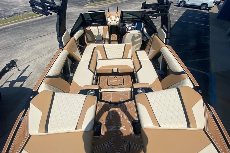 Slide: The Image of 2023 Tigé 23ZX boat interior with luxurious tan and cream seating. - 8