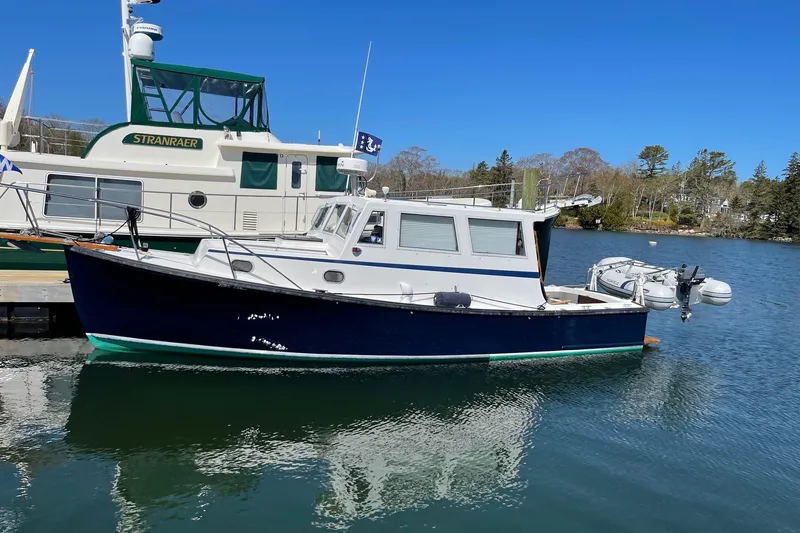 Slide: The Image of 1988 Ellis HARDTOP CRUISER boat docked on calm water, clear blue sky background. - 1