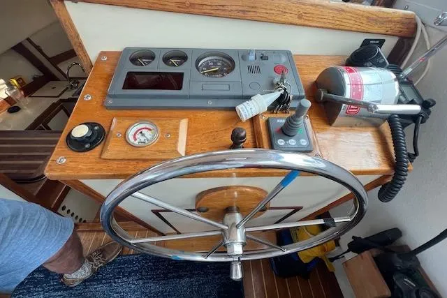 Slide: The Image of 1988 Ellis HARDTOP CRUISER helm with steering wheel, gauges, and fire extinguisher. - 10