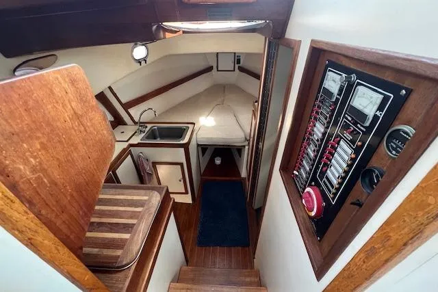 Slide: The Image of 1988 Ellis HARDTOP CRUISER interior with wood finish, kitchenette, and control panel. - 15