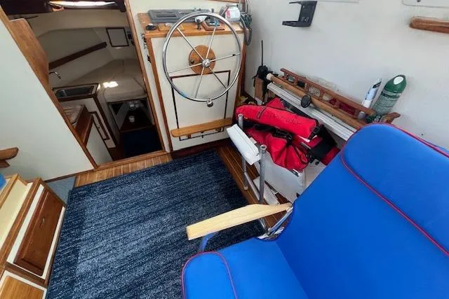 Slide: The Image of 1988 Ellis HARDTOP CRUISER interior with blue seating, steering wheel, and nautical equipment. - 17