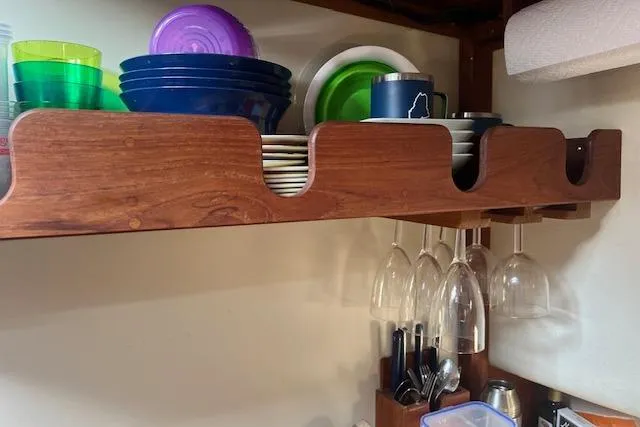 Slide: The Image of Wooden kitchen shelf with colorful dishes and hanging wine glasses. - 19