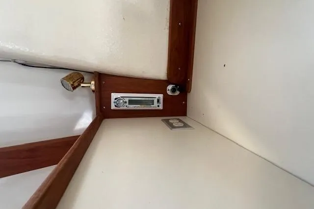 Slide: The Image of 1988 Ellis HARDTOP CRUISER interior with wood trim and vintage radio. - 24