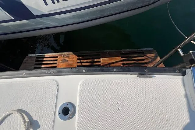 Slide: The Image of 1988 Ellis HARDTOP CRUISER boat docked with wooden platform visible. - 9