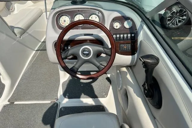 Slide: The Image of 2005 Chaparral 210 SSi boat dashboard with wood-trimmed steering wheel and instrument panel. - 10